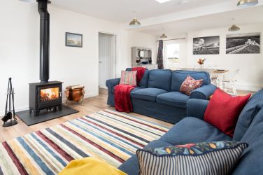 Cosy sitting room with log burning stove