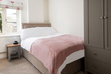 Single room with small double bed and view to the garden