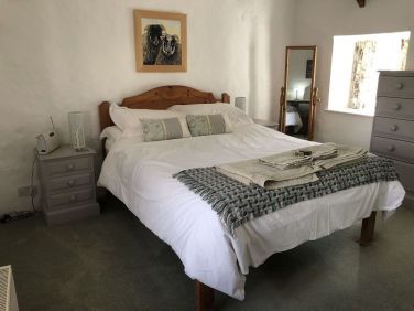 The master bedroom has a five foot bed, high ceilings and dual aspect windows.