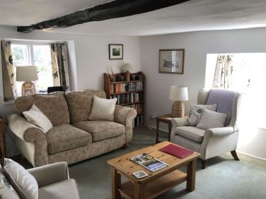 The bright sitting room has double aspect windows