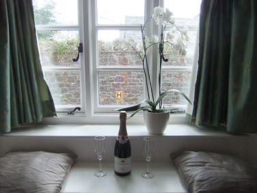 Enjoy a glass of wine in the sitting room window seat
