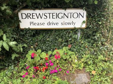The welcoming village road sign