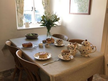 The dining table comfortably seats four in a sunny spot in the kitchen.