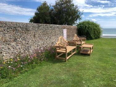 Seating overlooking the sea in the private Marine Parade gardens