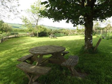 The well-fenced communal garden with picnic tables and views