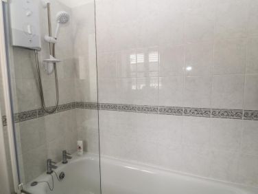 The shower is over the bath