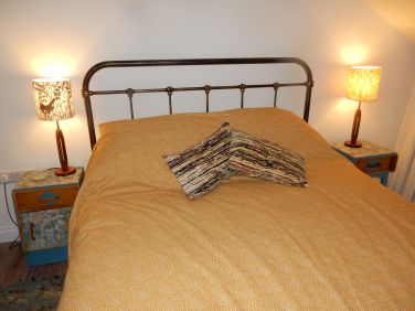 King size bed with cotton bedding, and allergy free sheep's wool duvet, mattress and pillows.