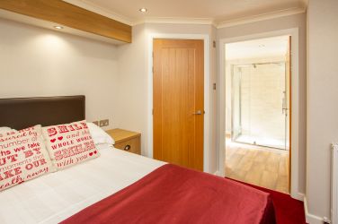 Master bedroom with king size bed and en suite shower room.