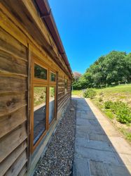 The entrance to Owl Lodge is at the side, on one level from the parking area.