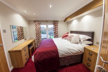 One of two king size beds in Owl Lodge, both with south-facing views across the valley