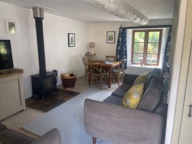 Butterdon's cosy living area with woodburner