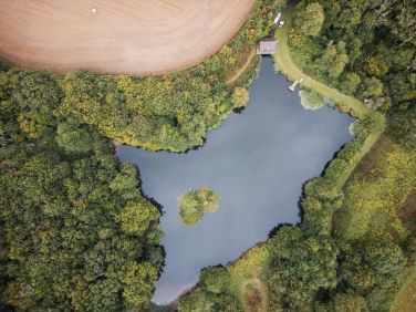 Clifford Barton's stunning lake with seating area and pontoon