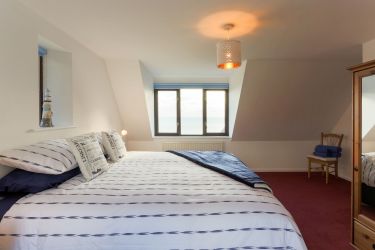 First floor family bedroom. Double aspect with sea views. Big super-king sized bed plus a single be