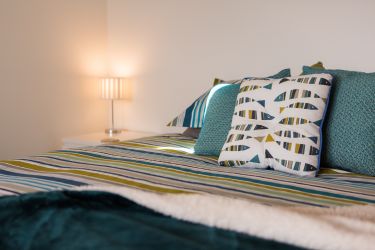 Ground floor Master suite with big super-king sized bed, sea views and door out onto a patio are