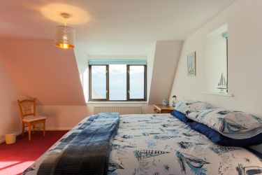 First floor family bedroom. Double aspect with sea views. Big super-king sized bed plus a single bed