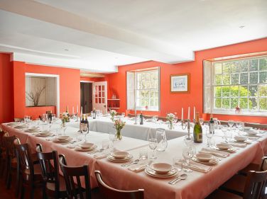 The red dining room seat all 31 guests together