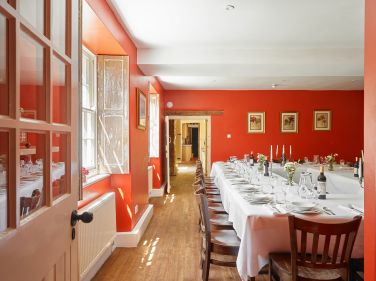 The red dining room looking from the cinema/party room