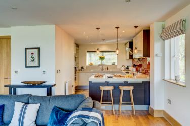 Fully stocked kitchen with bar stools and second under counter fridge