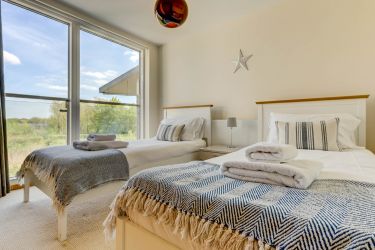 Twin bedroom on the first floor, with Juliette balcony overlooking the lake