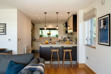 Fully stocked kitchen with bar stools and second under counter fridge