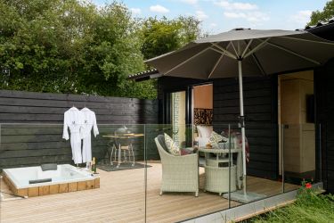 Private decking area with spa bath, seating and bbq