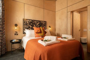 Bedrooms with warm orange tones to complement the industrial chic theme