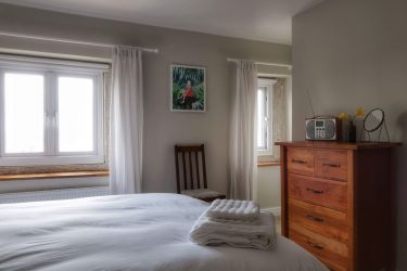 The bedroom looks out to the surrounding village with Black Rocks, Bolehill & Alport Heights beyond