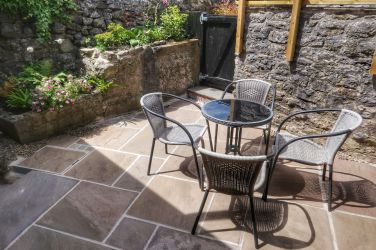 The rear courtyard offers a private spot to soak up the sun