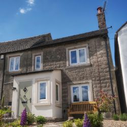 To the front of the cottage, there&rsquo;s a bench where you can sit and watch village life unfold