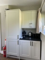 Coffee area in dining room with integrated fridge freezer