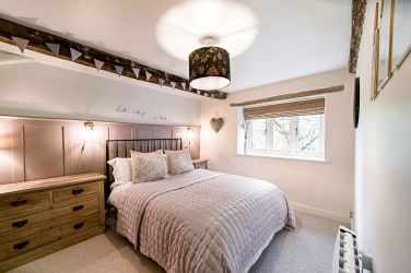 Spacious bedroom with king size bed and ample storage