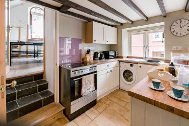 Newly fitted kitchen with electric oven, dishwasher and washing machine