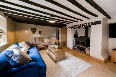 Large living area with huge 4 seater sofa and reading chairs