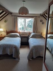 Spacious bedroom with large walk-in fitted wardrobe, television, and beautiful views to wake up too