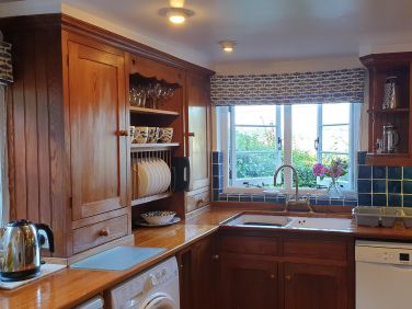 Laloma's kitchen has stunning views and is well equipped with a new hob and oven.