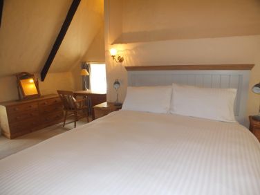 The master bedroom has a king sized bed and enjoys stunning creek views.