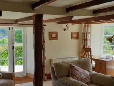 Laloma's sitting room has beautiful creek views and has a cosy log burner for chilly nights.