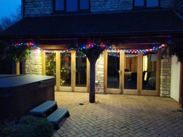 Early evening showing the hot tub and kitchen/diner