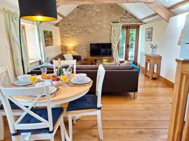 Open plan living space with Vaulted ceilings, exposed stone walls and solid English oak floors