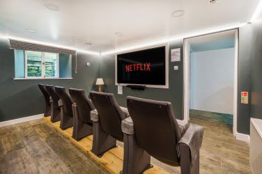 White Moss12 seat cinema with 75 inch Smart TV.