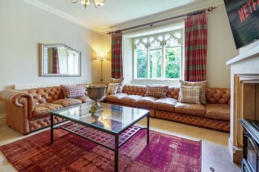 White Moss lounge with leather Chesterfield sofas.