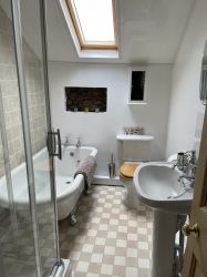 Bathroom with shower, roll top bath, wc and basin