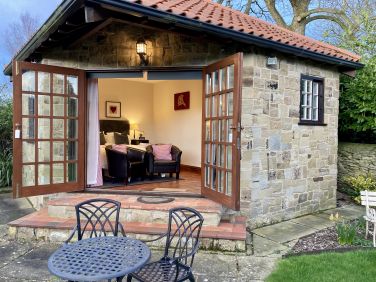 The Hideaway has large French doors opening onto the garden and terrace for alfresco dining