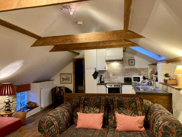 Apple Loft open plan living space with beams and stone walls