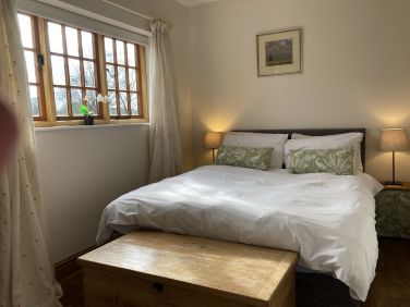 Ruth&rsquo;s cottage master bedroom with garden views and ensuite shower room and dressing room.