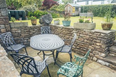 Garden furniture on the terrace accessed via the car parking space.