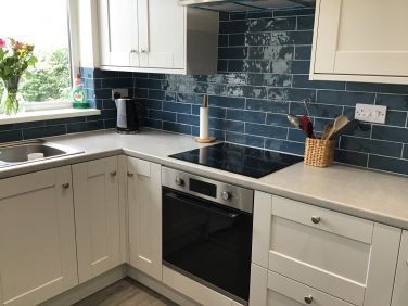 Kitchen showing oven and induction hob