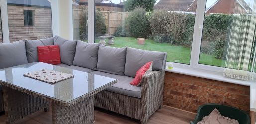 Conservatory showing dining table, looking out to garden