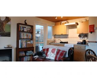 Cozy reading space and a kitchenette to the back of the sitting room
