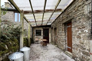 Car port space providing sheltered outside space outside the utility room.